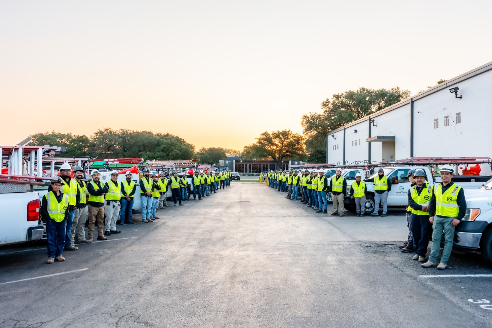 Crest Electrical and Mechanical Solutions team with service vehicles